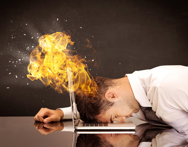 Stressed business man's head is burning - Foto, afbeelding