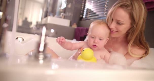 Mom Takes Bubble Bath with Infant Daughter - Materiaali, video