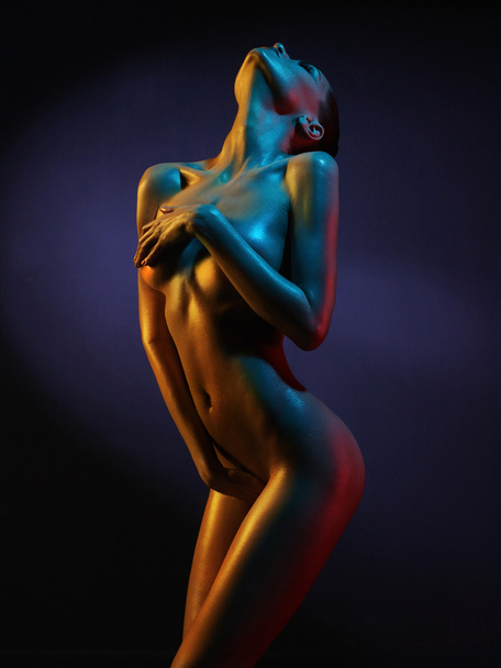 Elegant nude model in the light colored spotlights - Foto, Bild