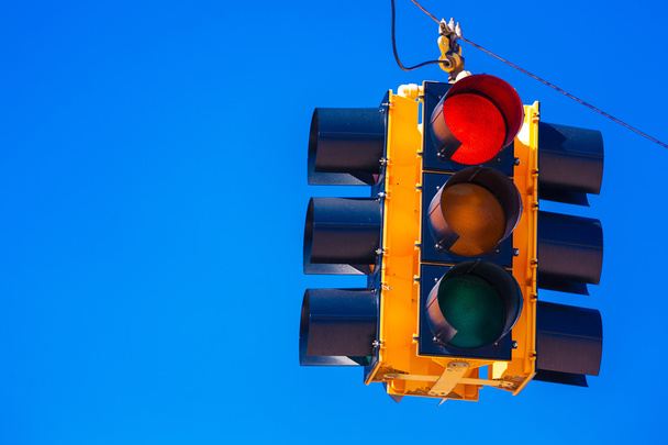 A red traffic light with a sky blue background - Photo, Image