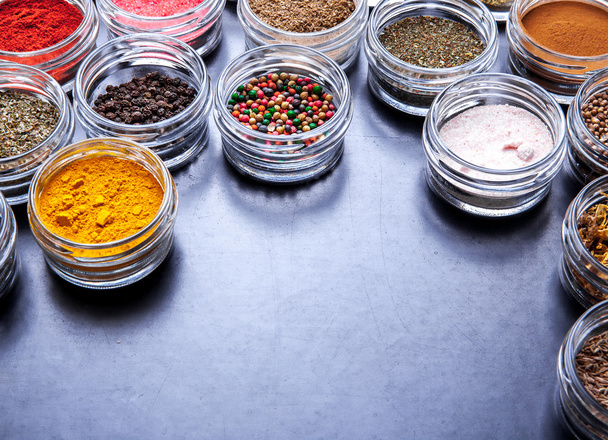 Spices on black background in special jars. Food - Photo, Image