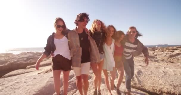Hipster friends embracing joyfully on seaside - Footage, Video