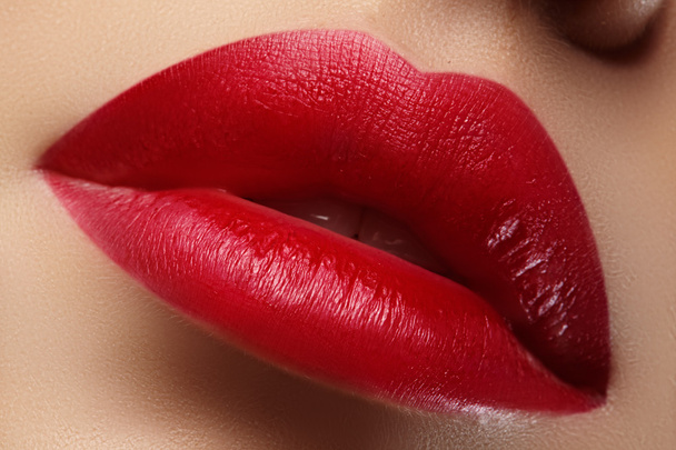 Close-up of woman's lips with fashion red make-up. Beautiful female mouth, full lips with perfect makeup. Classic visage. Part of female face. Macro shot of beautiful make up on full lips. - Photo, Image