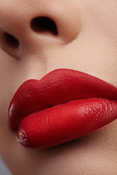 Close-up of woman's lips with fashion red make-up. Beautiful female mouth, full lips with perfect makeup. Classic visage. Part of female face. Macro shot of beautiful make up on full lips. - Fotografie, Obrázek
