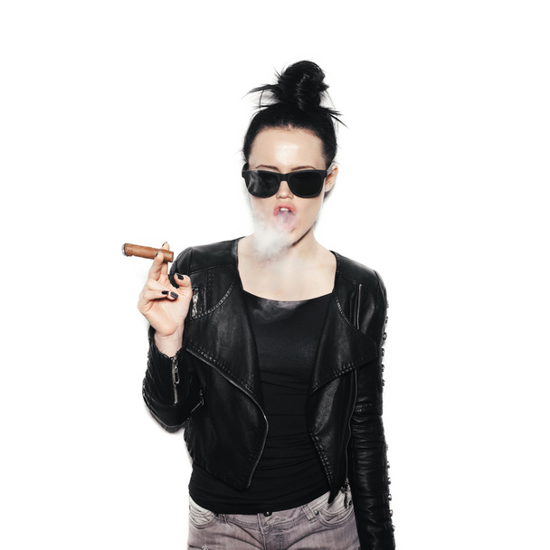 Sexy woman in sunglasses blowing smoke from a cigar - Фото, изображение