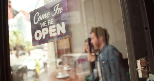 Open Sign on Glass Door of Coffee Shop - Materiał filmowy, wideo