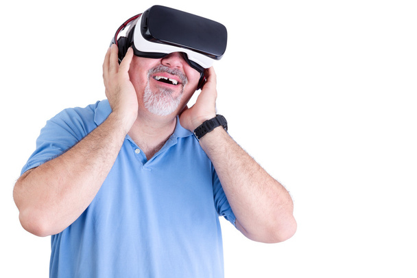 Smiling man holds virtual reality glasses to face - Foto, imagen