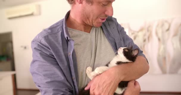 Dad Holding Cat on his arms and smiles - Filmagem, Vídeo