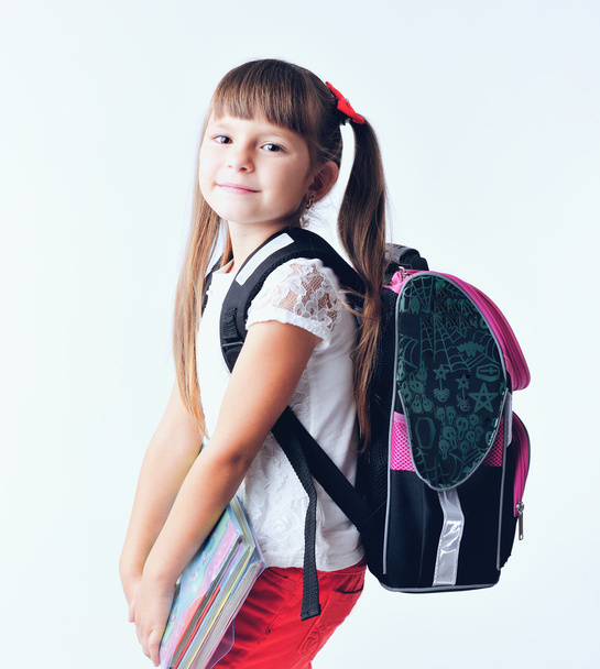 Portrait of teenager girl with school backpack holding colored folders isolated on white background - Φωτογραφία, εικόνα