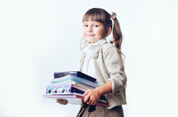 Portrait of teenager girl with school backpack holding colored folders isolated on white background - Foto, imagen
