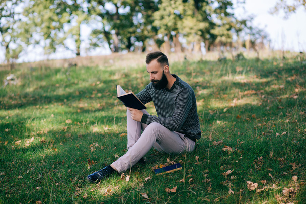 Bearded man reading a book - Photo, Image