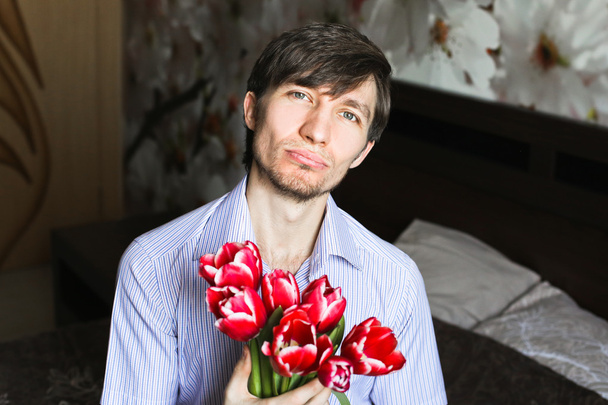 Womens day, the guy with red tulips - Zdjęcie, obraz