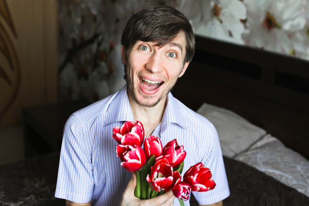 Womens day, the guy with red tulips - Φωτογραφία, εικόνα