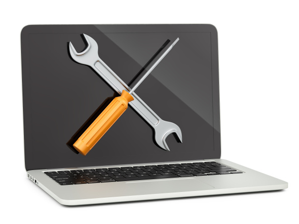 laptop met een moersleutel en schroevendraaier - Foto, afbeelding