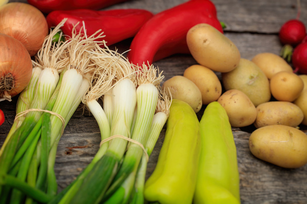 Various fresh raw vegetables on wooden surface - Фото, зображення