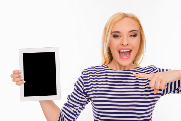 Pretty happy young girl pointing on screen of tablet - Foto, immagini