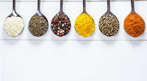 colorful spices in iron spoons - Φωτογραφία, εικόνα