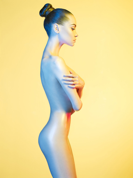 Elegant nude model in the light colored spotlights - Foto, immagini