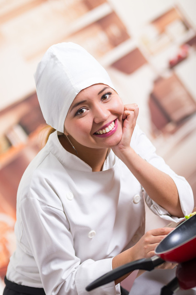 Nice portrait of woman chef wearing cooking outfit leaning on kitchen counter smiling to camera - Valokuva, kuva