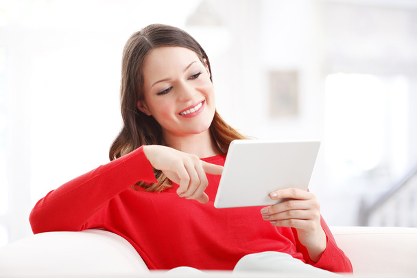 woman using digital tablet while sitting - Фото, зображення