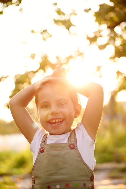 little girl outside smiling happily - Фото, изображение