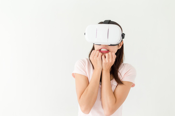 Woman watching scary movie with VR device - Photo, Image