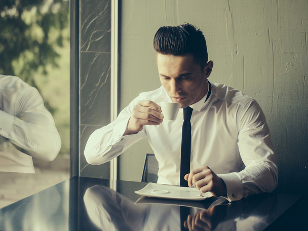 Young man drinks coffee  - Foto, imagen