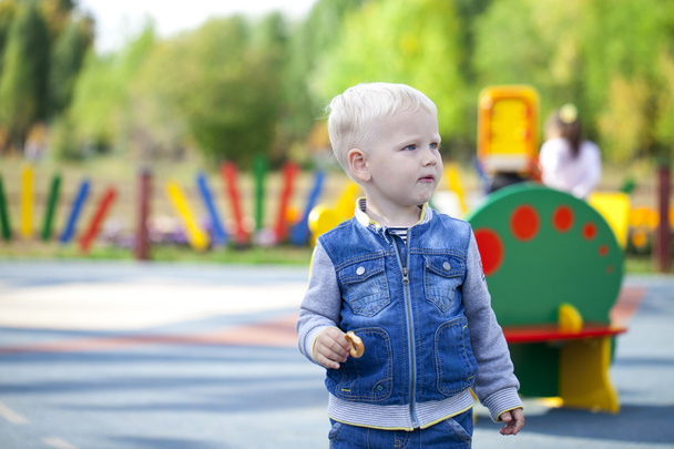 Cheerful little boy running around on the playground - Foto, Imagem