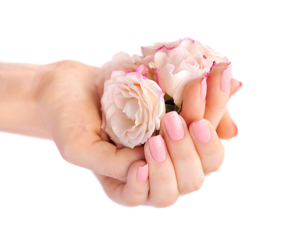 Mãos de uma mulher com rosas rosa isoladas no fundo branco
 - Foto, Imagem
