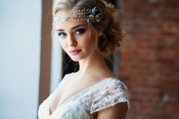 Beautiful blonde bride in gorgeous luxury dress in a loft space in a morning. Modern wedding photo - Φωτογραφία, εικόνα
