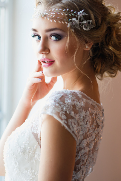 Beautiful blonde bride in gorgeous luxury dress in a loft space in a morning. Modern wedding photo - Photo, Image