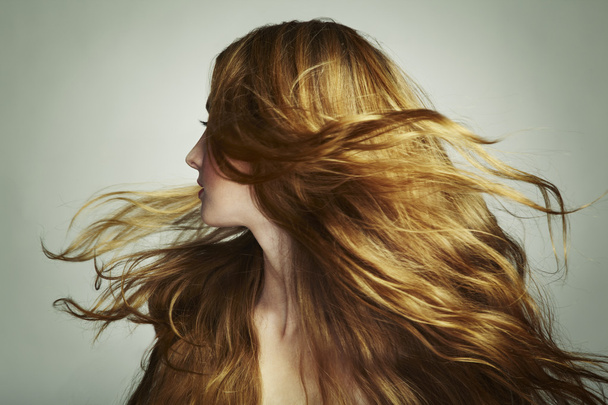 Portrait of young beautiful woman with long flowing hair - Фото, изображение