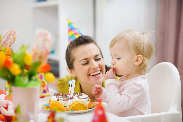 Mother spending fun time with baby on birthday party - Фото, изображение