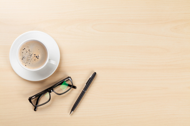 Escritorio de oficina con café, bolígrafo y vasos
 - Foto, Imagen