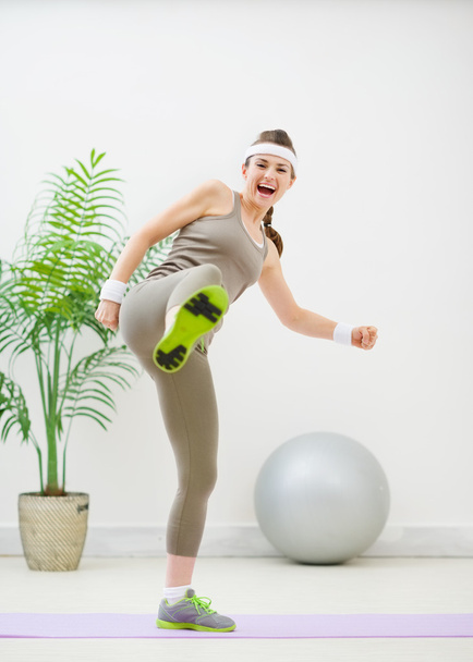 Fitness woman in sportswear kicking - Фото, зображення