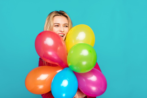 blonde woman with balloons on blue - Foto, imagen