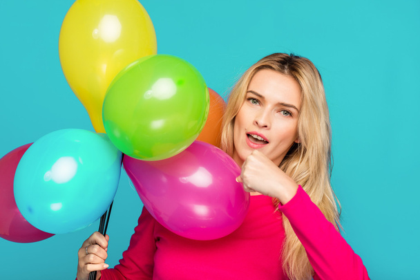 blonde woman with balloons on blue - Фото, изображение