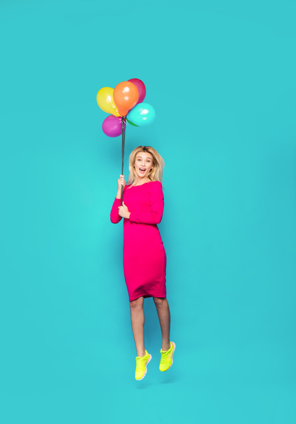 blonde woman with balloons on blue - Photo, Image