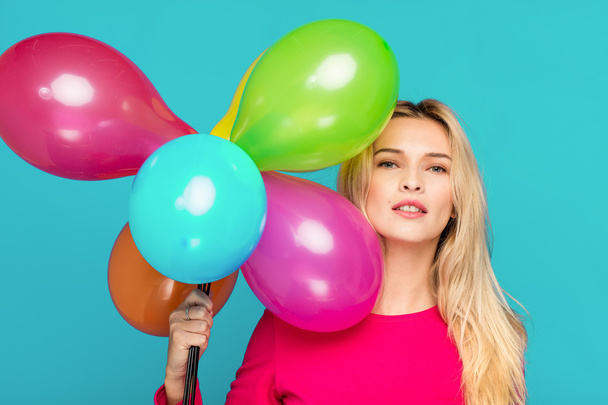 blonde woman with balloons on blue - Foto, imagen