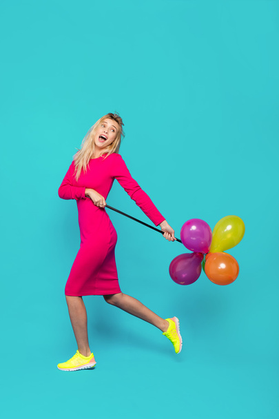 blonde woman with balloons on blue - Zdjęcie, obraz