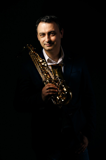 musician man with saxophone. drama light. - Fotografie, Obrázek