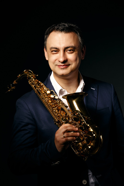 musician man with saxophone. drama light. - Fotoğraf, Görsel