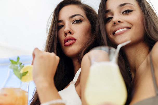 Attractive girls drinking cocktails - Фото, зображення