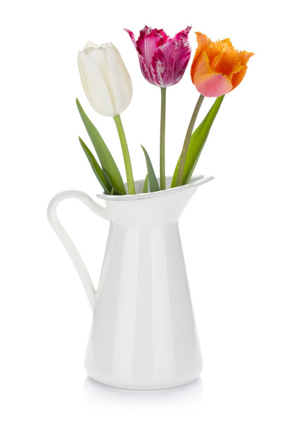 Colored tulips in a jug - Фото, изображение