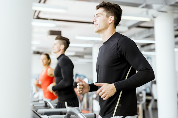 Group of people using treadmills in a gym - Фото, зображення