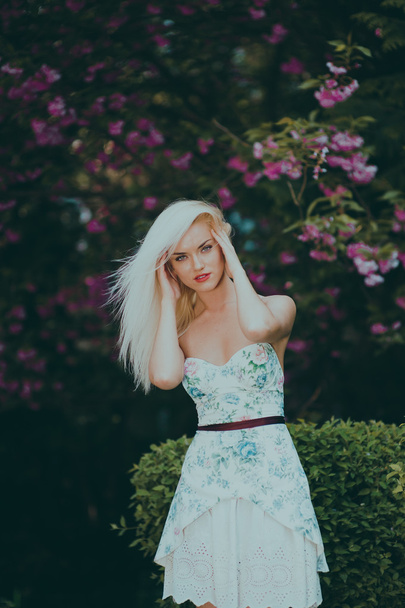 beautiful blond girl in garden - 写真・画像