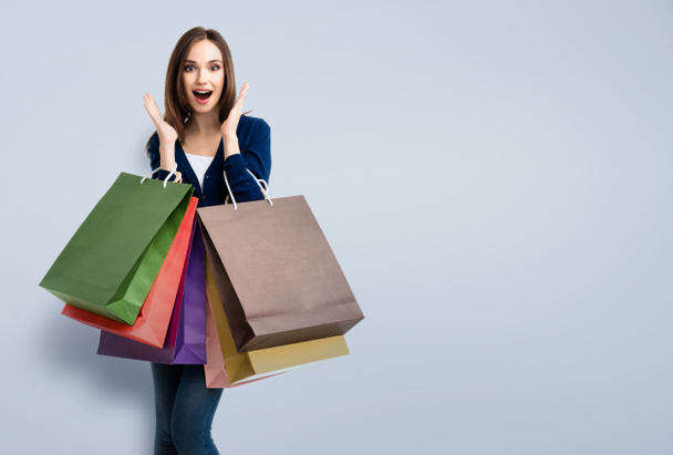 woman in casual clothing with shopping bags, with copyspace  - Fotó, kép