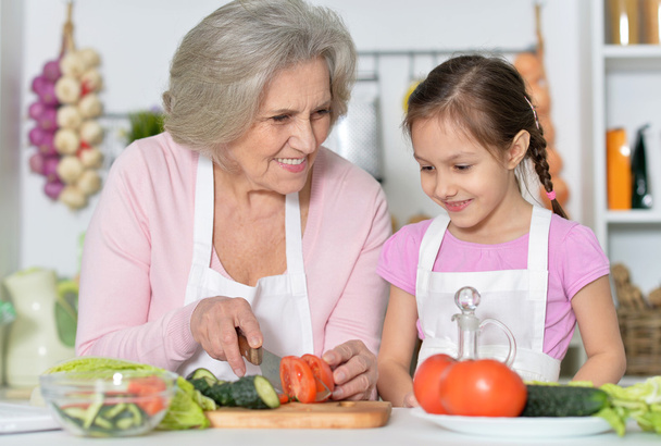 Senior woman with granddaughter cooking - Foto, imagen