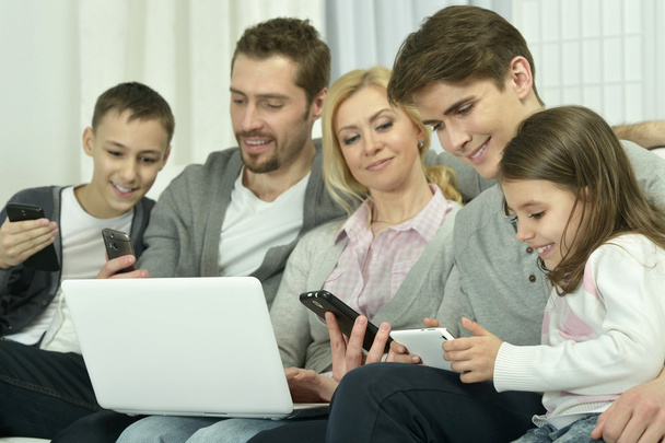 happy family with electronic gadgets - Foto, afbeelding