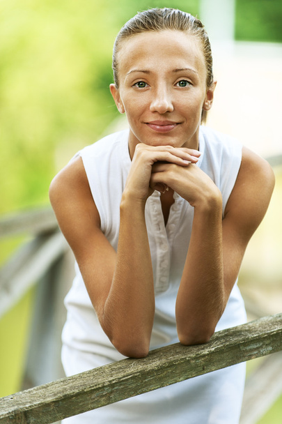 Young woman leaned on wooden railing - Photo, Image